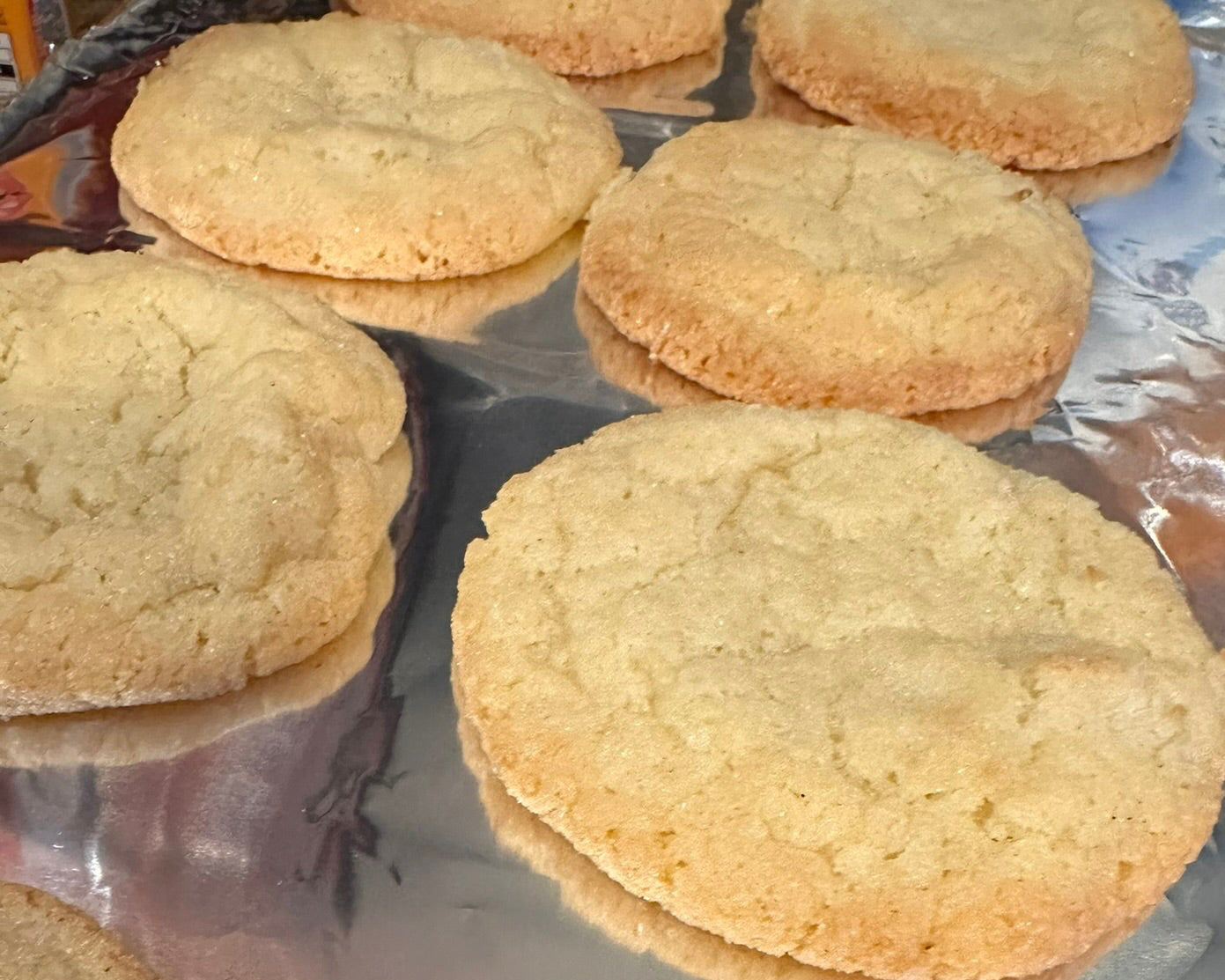 Cookies on a baking tray with a reflective surface